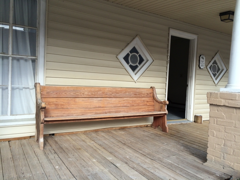 Bench on Cox Hotel front porch for watching passers-bye.